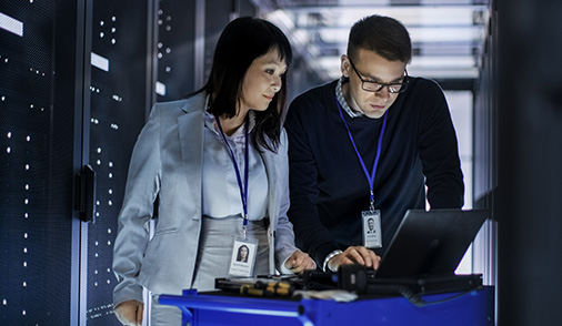 Man and woman stand in Data Backup and Recovery center