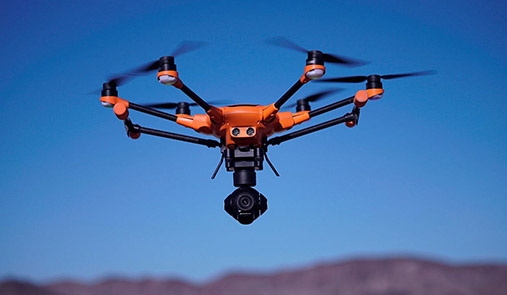 Yuneec drone in flight above mountains with a close-up of all 6 rotors